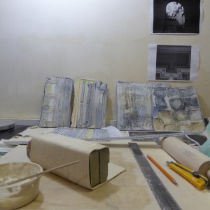 my desk littered with some tiles and limoges